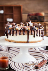 Two-ply chocolate cheesecake decorated with candies and frosting