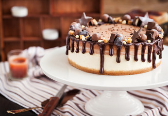 Two-ply chocolate cheesecake decorated with candies and frosting