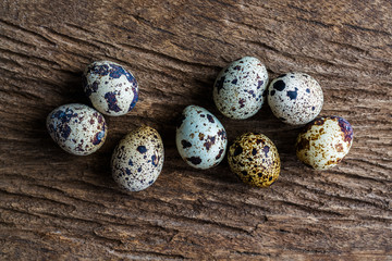 Quail eggs on wood table, top view