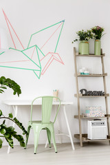 Room with mint chair and washi tape on the wall.