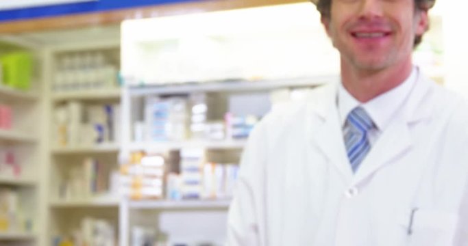 Pharmacist giving pill bottle to customer
