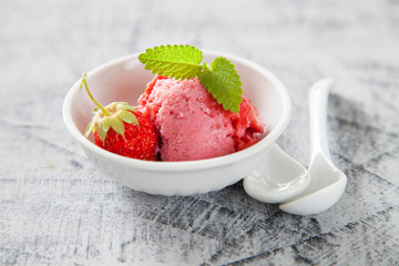 ice cream, red sorbet with strawberry on a concrete background, selective focus