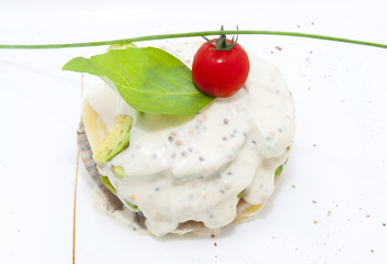 Herring salad with avocado sauce on a plate in a restaurant