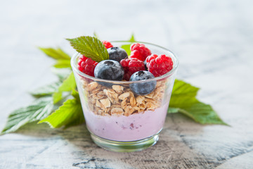 yogurt and muesli with berries on a table, selective focus,
