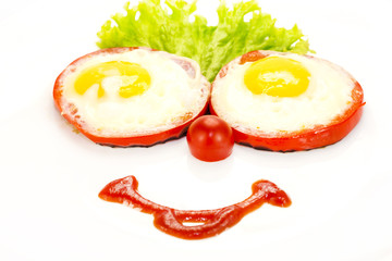 Eggs as a smiley face adorned with greenery on a white plate