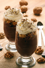 Chocolate pudding with walnuts and whipped cream.
