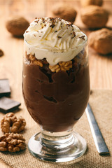 Chocolate pudding with walnuts and whipped cream.
