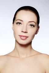 Fototapeta premium Beautiful model with natural fashion make-up. Close-up portrait sexy woman with glamour lip gloss makeup and long eyelashes. Celebrate visage, clean skin, eyebrows, lashes. Beautiful Smile