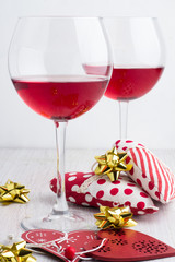 wine glasses and toys hearts on a white background