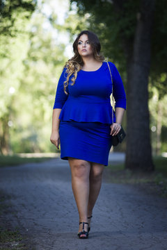 Young beautiful stylish plus size fashion model in blue dress outdoors, xxl  woman on nature Stock Photo | Adobe Stock