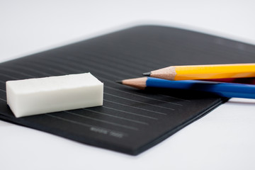 image of a notebooks and pencil on the desk, close-up