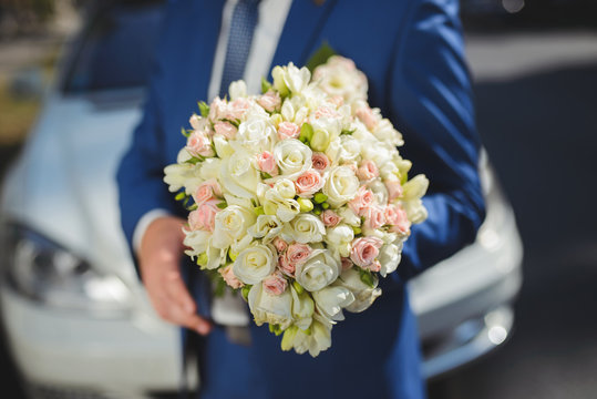 Groom in Blue Suit with Bouquet