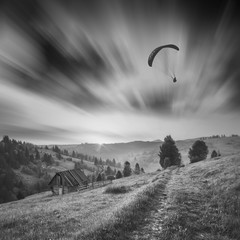 Paraglide in a sky. Monochrome picture