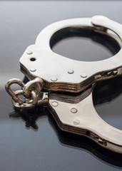 Obraz premium Handcuffs isolated on black