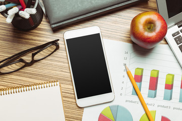 Office table with  smartphone on it. View from above