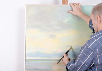 An artist painting in studio. Selective focus