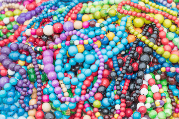 The pile of multicolored necklaces made of wooden beads 