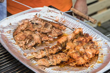 Street food - Grilled skewers of salmon prepared  on the farmers market.