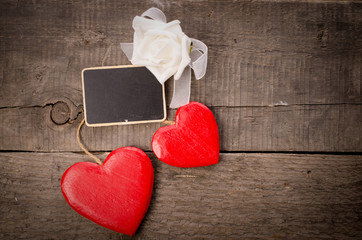 Two red wooden heart shapes