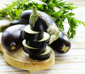 natural fresh organic eggplants on a wooden table