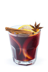 Cup of hot wine with spices on white background