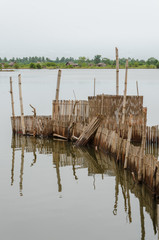 Traditional reed fishing traps used in wetlands near the coast in Benin. - obrazy, fototapety, plakaty