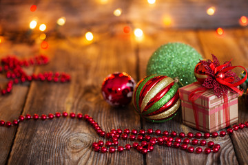 Christmas balls and Christmas gift on wooden background