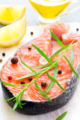 Steak of fresh salmon with aromatic herbs and spices close-up