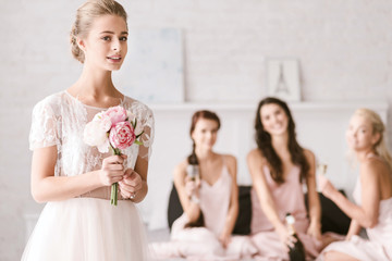 Cute bride standing in the white room