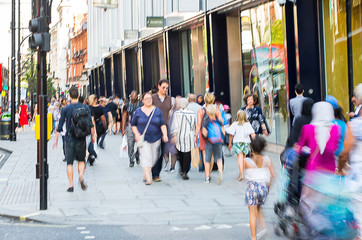 Blurred image of walking people. Londoners and tourists walking in Oxford street, one of the main...