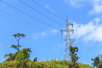 Obraz premium High voltage electric tower on the mountain and blue sky