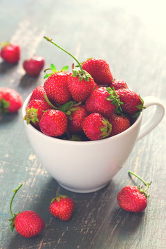 Garden strawberries in a white cup, tinted