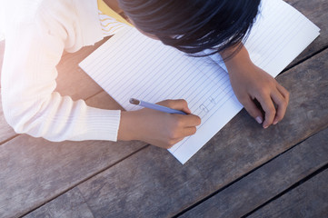 kids doing homework on old wood table.kids concept.