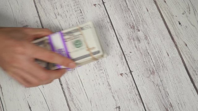 Top view drug deal. Giving cocaine and receiving cash in the hand.