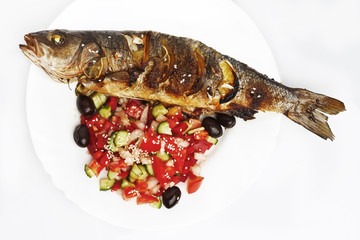 Cooked fish sea bream fish with lemon, parsley,garlic.