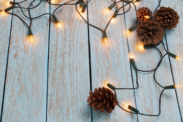 christmas lights on blue wooden background