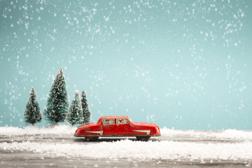 Vintage toy car in a winter landscape