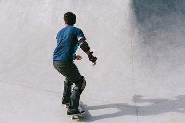 Young skateboarder at sunset at a skatepark