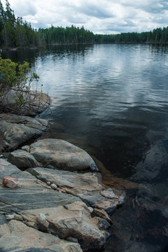 view of calm lake from rocky shore