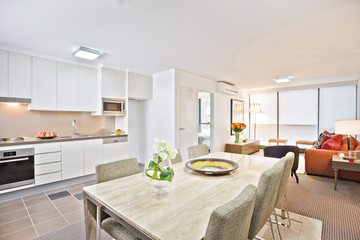 Luxury kitchen with white  dining table and sofa.