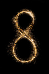 New year font sparkler number eight on black background