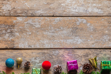 Christmas background with decorations and gift boxes on wooden b