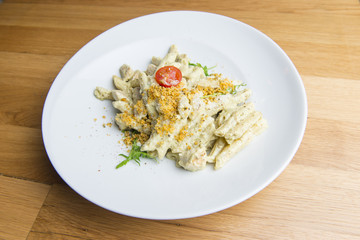 Pasta in cream sauce with chicken meat, tomato, cheese