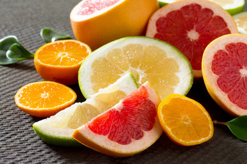 Citrus set of grapefruits and tangerines on a concrete gray back