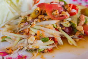 Thai spicy papaya salad serve with vegetables