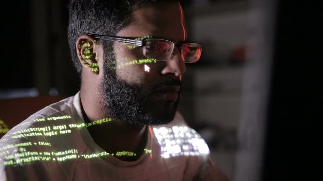 Male hacker works on a computer with data on screens. HD.