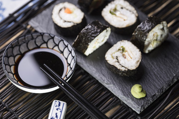 soy sauce and wooden chopsticks. selective focus