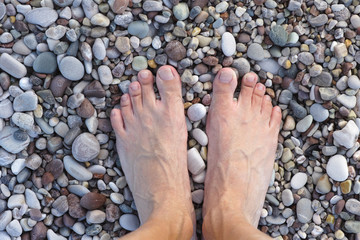 Feet on pebbles or stones