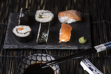 plate of japanese sushi and soy sauce and wooden chopsticks. sel