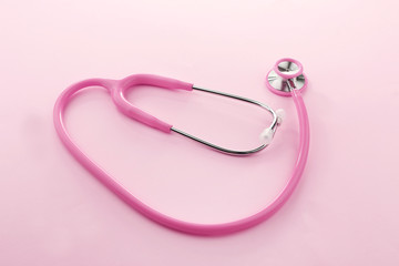 Pink stethoscope on pink background